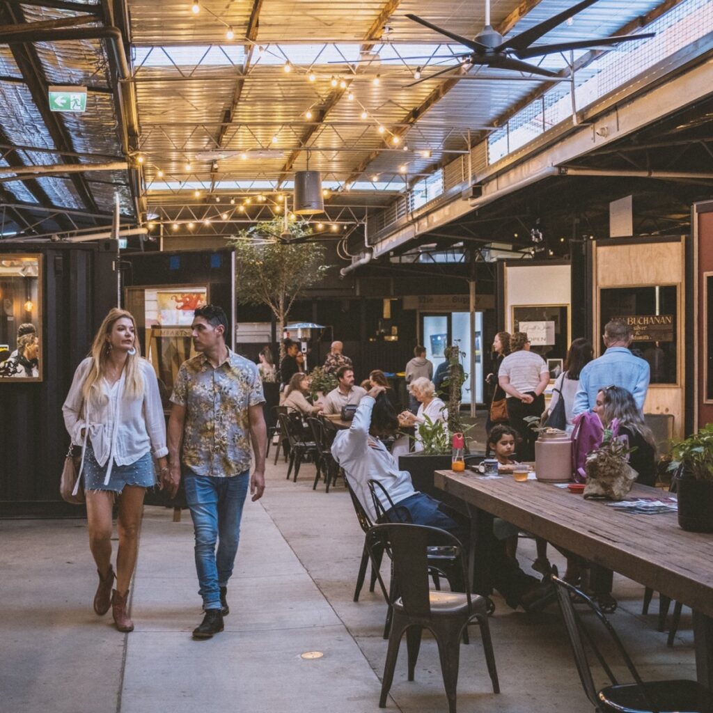 Couple walking through M Arts Precinct