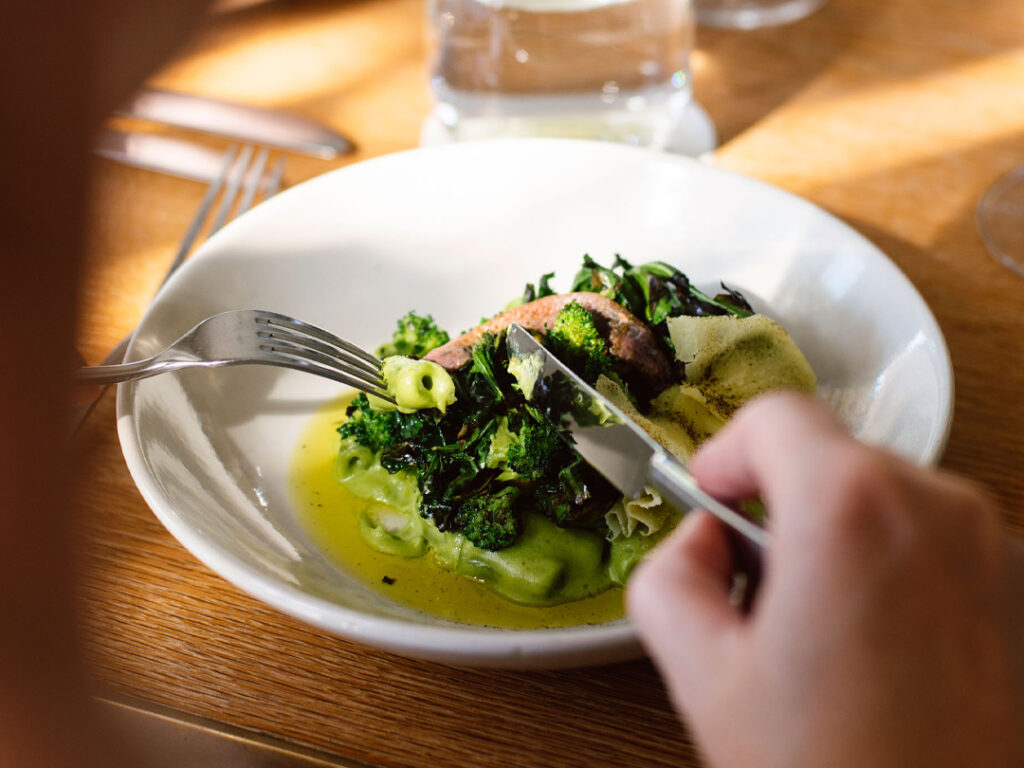 Shot of person eating dinner at paper daisy restaurant in cabarita beach