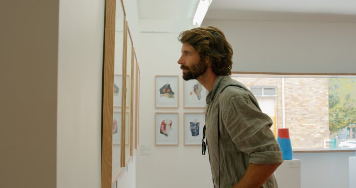 man looking at art in a gallery-Visit Tweed NSW