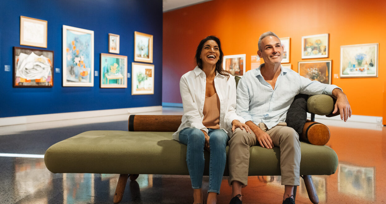 Couple admiring art at the Margaret Olley Far From a Still Life exhibition