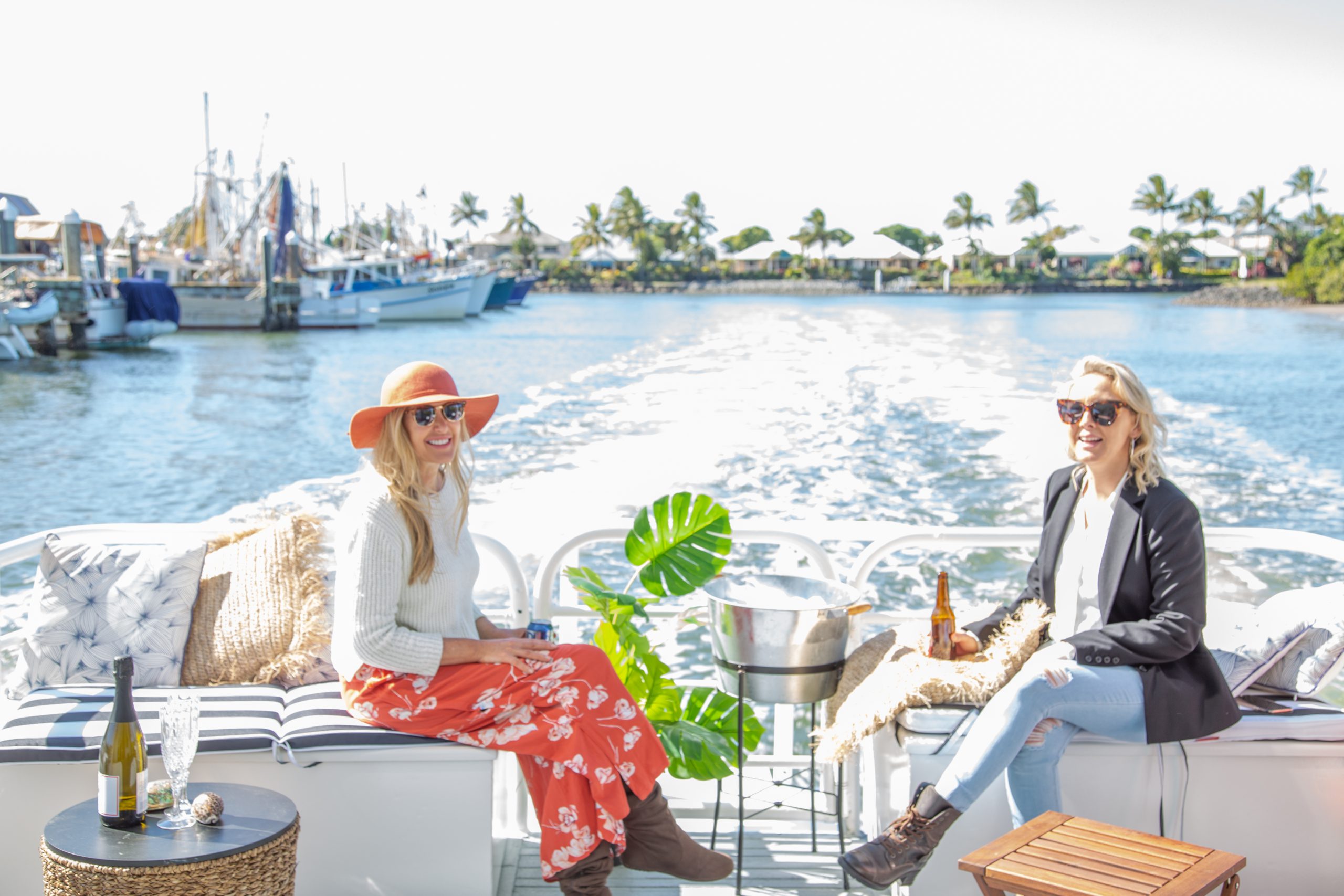 Two ladies on a boat cruising down the river