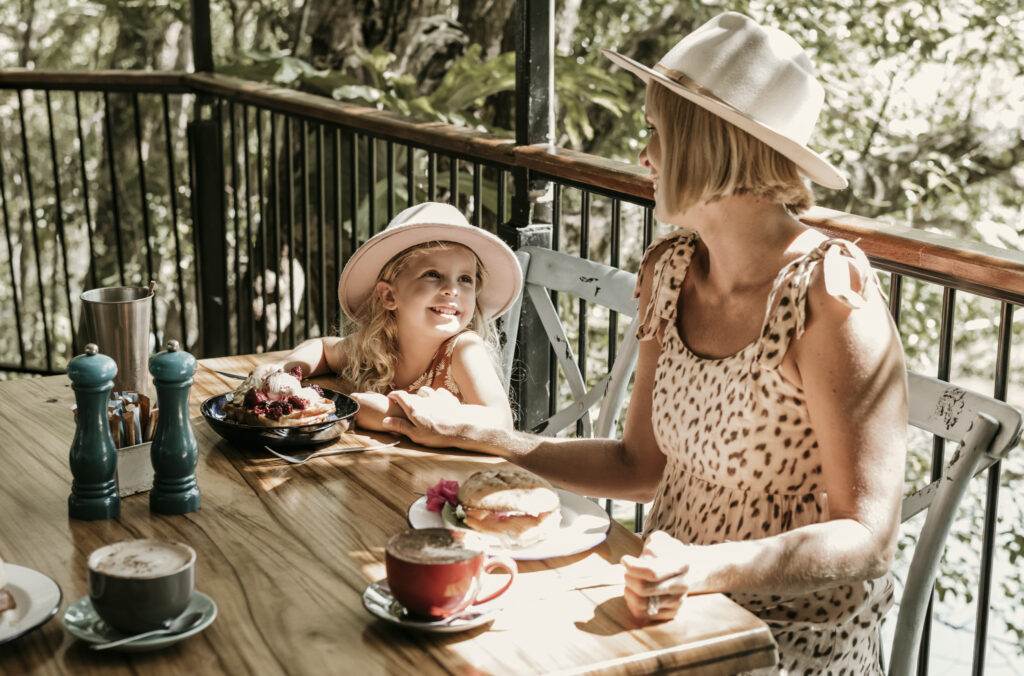 Mum and daughter eating breakfast at Crystal Creek Estate